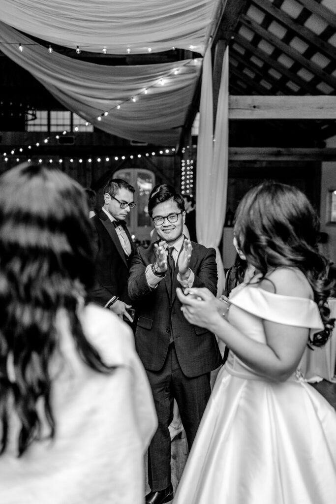 A guest applauding the bride on the dance floor of her Loudoun County wedding
