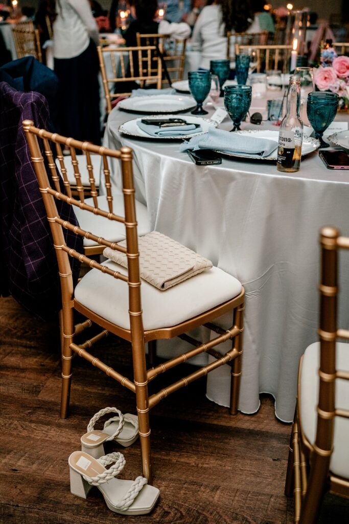 A pair of heels and purse left behind on a chair during a Shadow Creek wedding reception